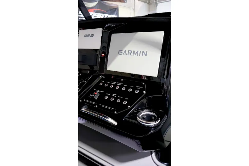 Slide: The Image of Dashboard of 2025 Sunsation 32 CCX featuring Garmin and Simrad displays. - 27