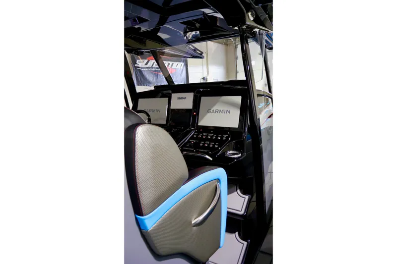 Slide: The Image of 2025 Sunsation 32 CCX boat cockpit with Garmin navigation displays and modern controls. - 26