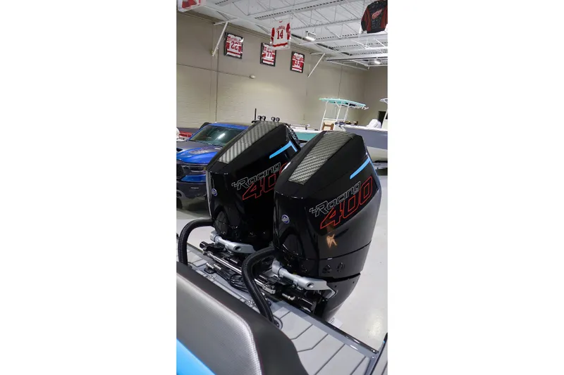 Slide: The Image of 2025 Sunsation 32 CCX with dual Racing 400 outboard engines in showroom. - 16