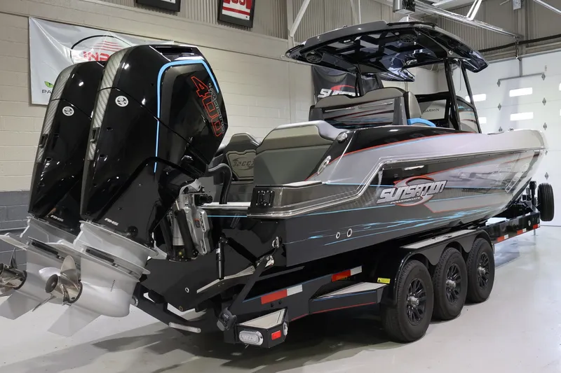 Slide: The Image of 2025 Sunsation 32 CCX boat with dual engines on a trailer in a showroom. - 9