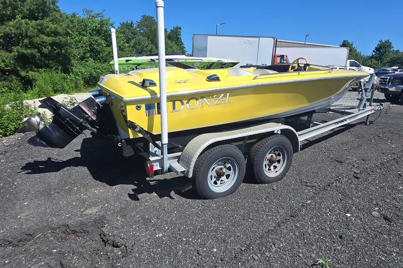 Slide: The Image of Yellow 1994 Donzi 18 Classic boat on trailer, parked outdoors. - 2