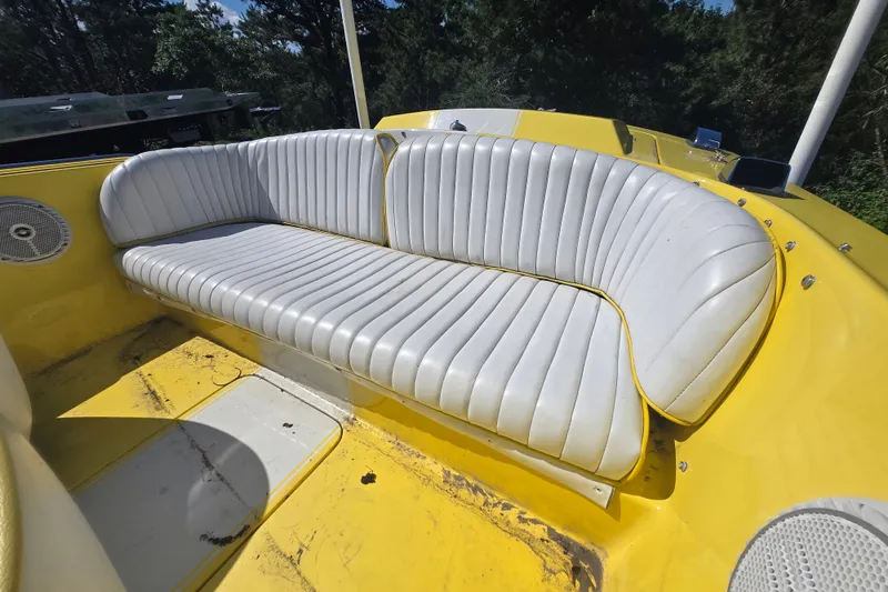 Slide: The Image of Yellow 1994 Donzi 18 Classic boat with white cushioned seating, set against a forest backdrop. - 8