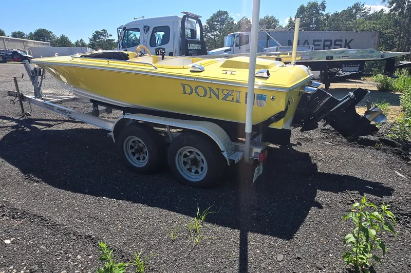 Slide: The Image of Yellow 1994 Donzi 18 Classic boat on trailer, parked outdoors in a sunny area. - 5