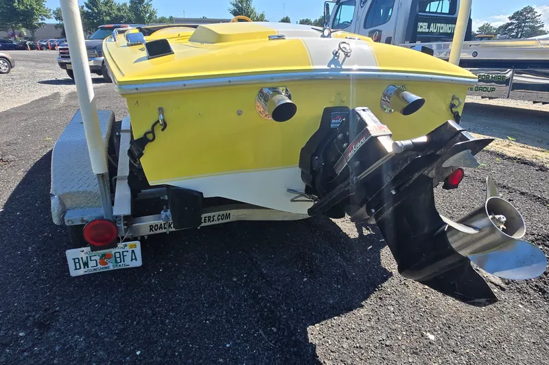 Slide: The Image of Yellow 1994 Donzi 18 Classic boat on trailer, rear view with propeller visible. - 6