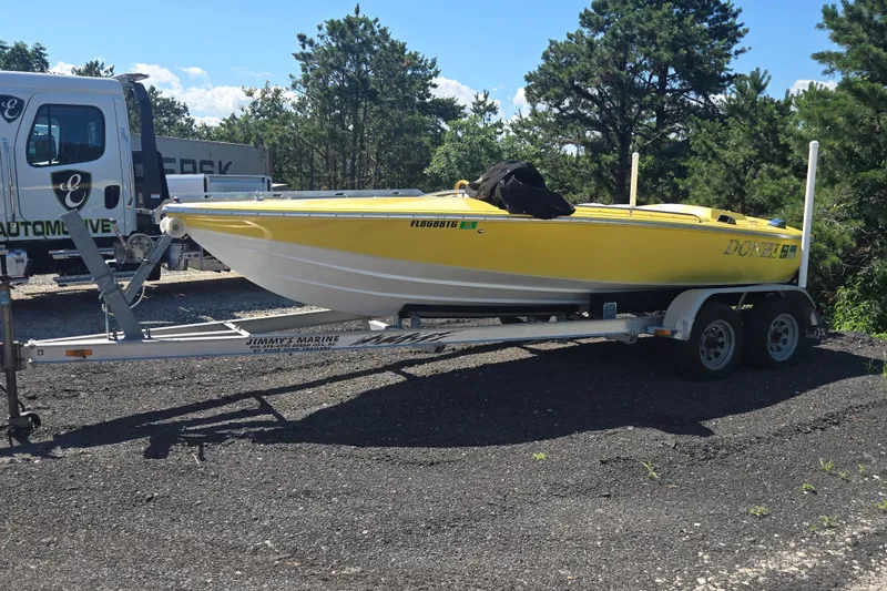 Slide: The Image of Yellow 1994 Donzi 18 Classic boat on trailer, parked outdoors. - 7