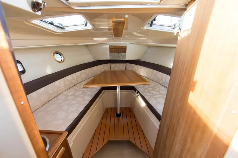 Slide: The Image of Manufacturer Provided Image: 2018 Ranger Tugs R-23 cabin interior with seating and table. - 7