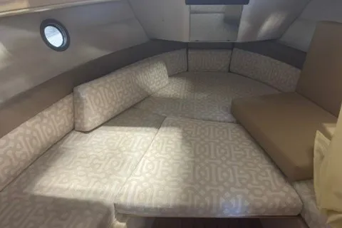 Slide: The Image of 2018 Ranger Tugs R-23 cabin interior with patterned seating and porthole window. - 18