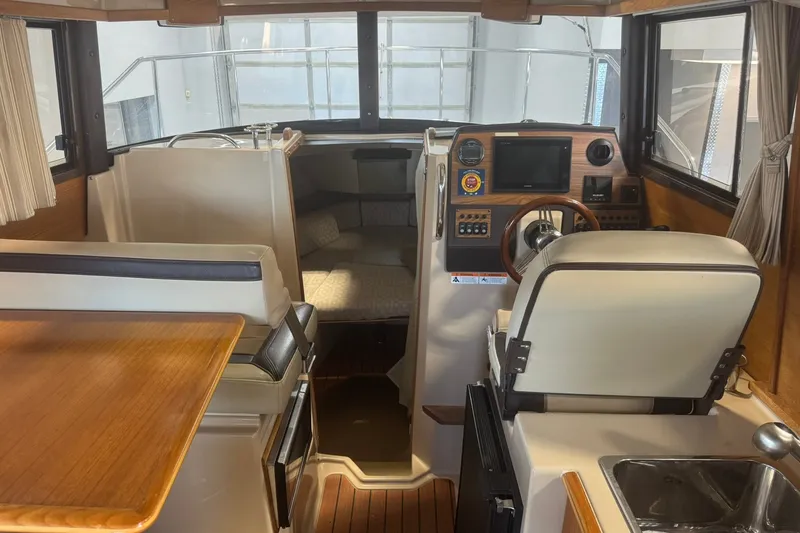 Slide: The Image of Interior of 2018 Ranger Tugs R-23 boat with helm, seating, and kitchenette. - 11
