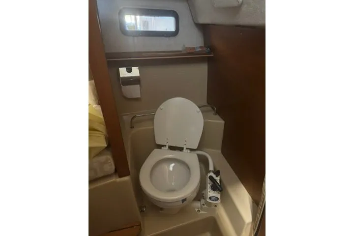 Slide: The Image of 2018 Ranger Tugs R-23 boat bathroom with toilet and window. - 20