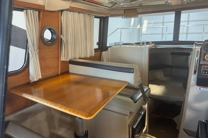 Slide: The Image of Interior of 2018 Ranger Tugs R-23 boat with dining area and cabin. - 13