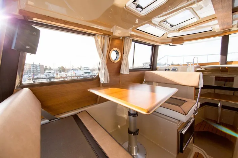 Slide: The Image of Manufacturer Provided Image: Interior of 2018 Ranger Tugs R-23 boat with dining area and windows. - 5