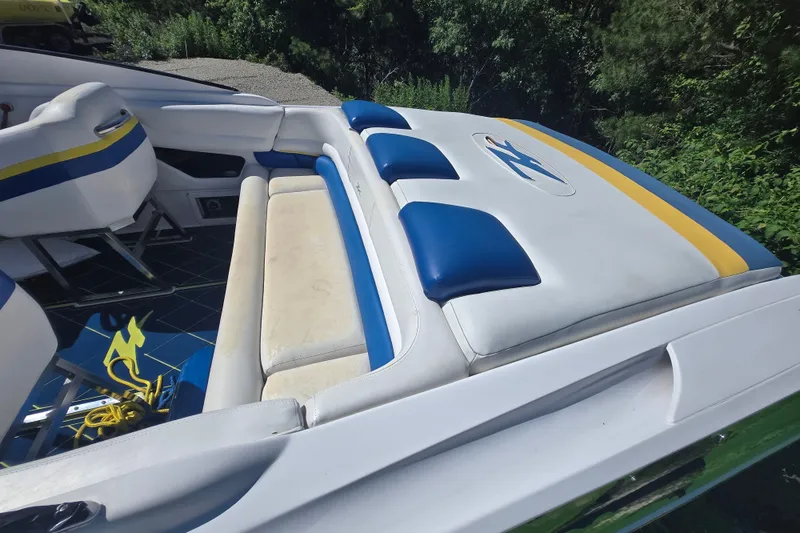 Slide: The Image of Interior of a 1998 Donzi 28 ZX boat with blue and yellow seating. - 17