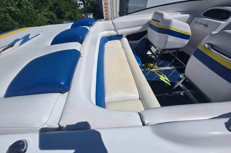 Slide: The Image of 1998 Donzi 28 ZX boat interior with blue and white seating and yellow accents. - 14