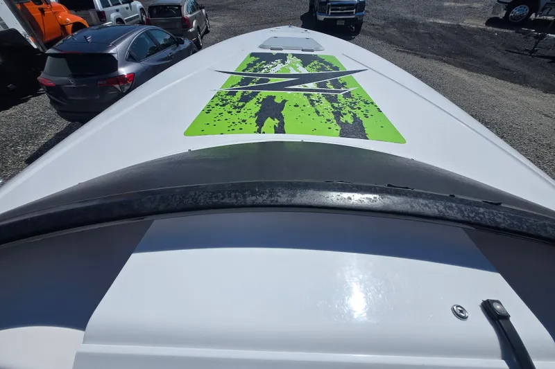 Slide: The Image of 1998 Donzi 28 ZX boat with vibrant green and black graphics on deck. - 24