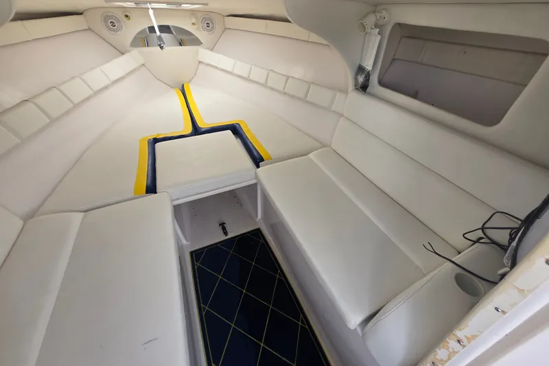 Slide: The Image of Interior of a 1998 Donzi 28 ZX boat with white seating and blue accents. - 19