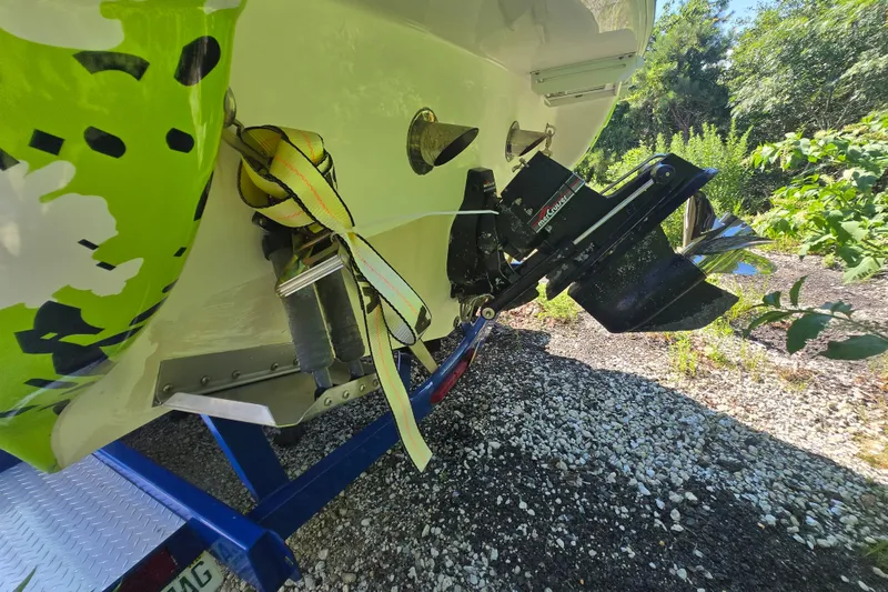 Slide: The Image of 1998 Donzi 28 ZX boat rear view with vibrant green design and trailer. - 25