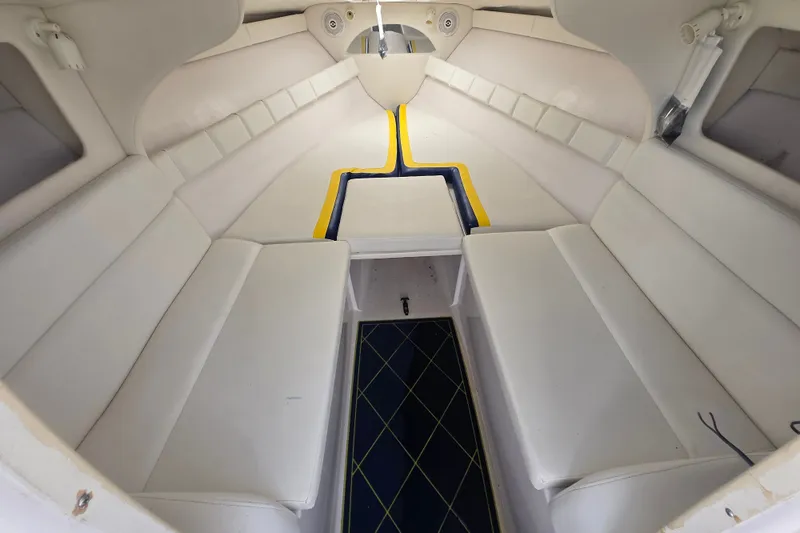 Slide: The Image of Interior of a 1998 Donzi 28 ZX boat with white seating and blue accents. - 3