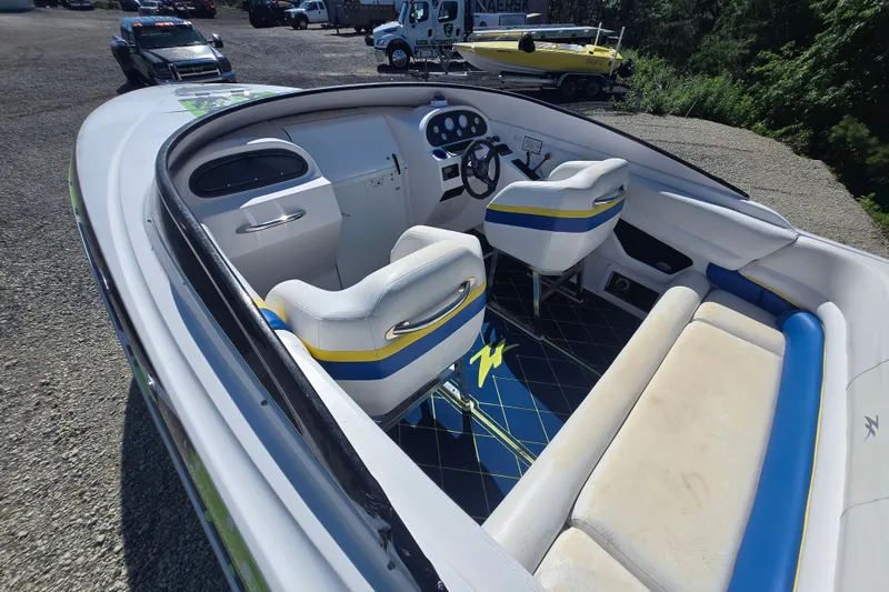 Slide: The Image of 1998 Donzi 28 ZX boat interior with white and blue seating, steering wheel, and dashboard. - 1