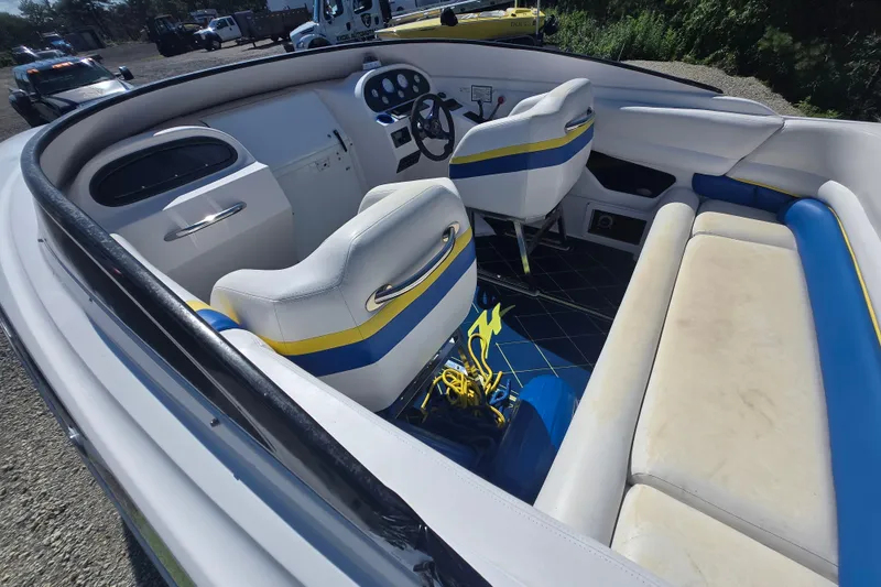 Slide: The Image of 1998 Donzi 28 ZX boat interior with white, blue, and yellow seating and dashboard. - 18