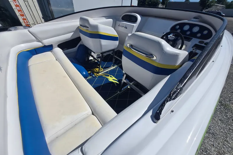 Slide: The Image of 1998 Donzi 28 ZX boat interior with white, blue, and yellow seating and dashboard. - 6