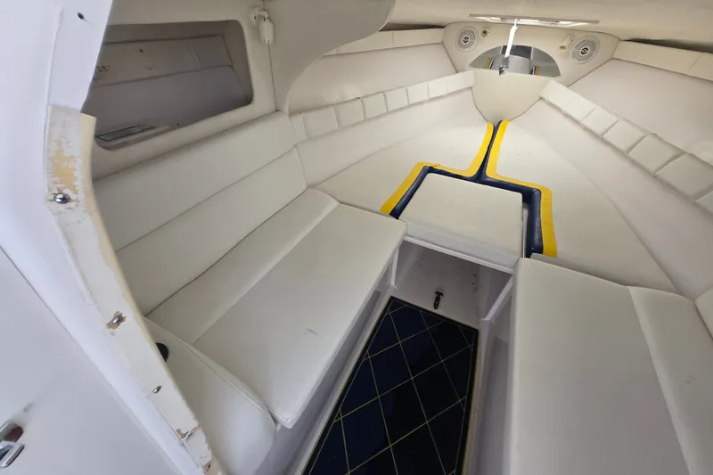 Slide: The Image of Interior of a 1998 Donzi 28 ZX boat with white seating and blue accents. - 20