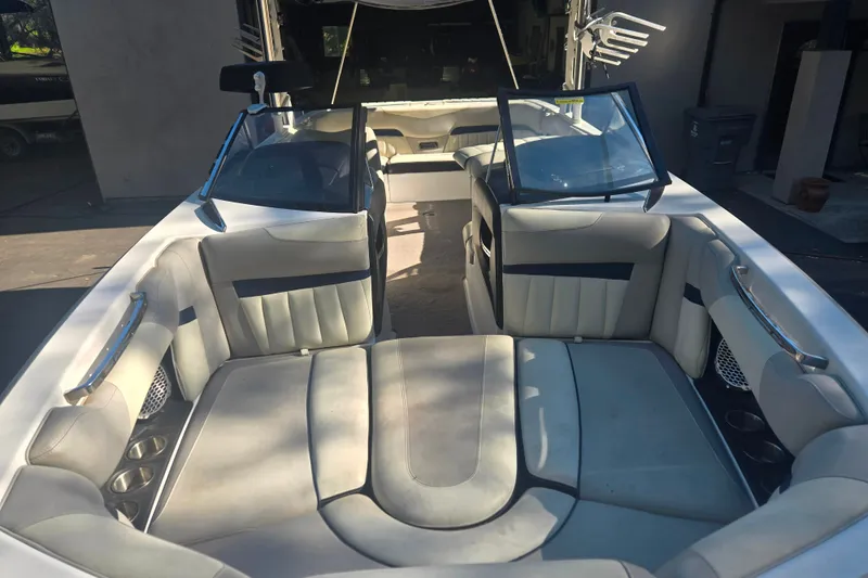 Slide: The Image of 2013 Malibu Wakesetter 24 MXZ boat interior with spacious seating and cup holders. - 2