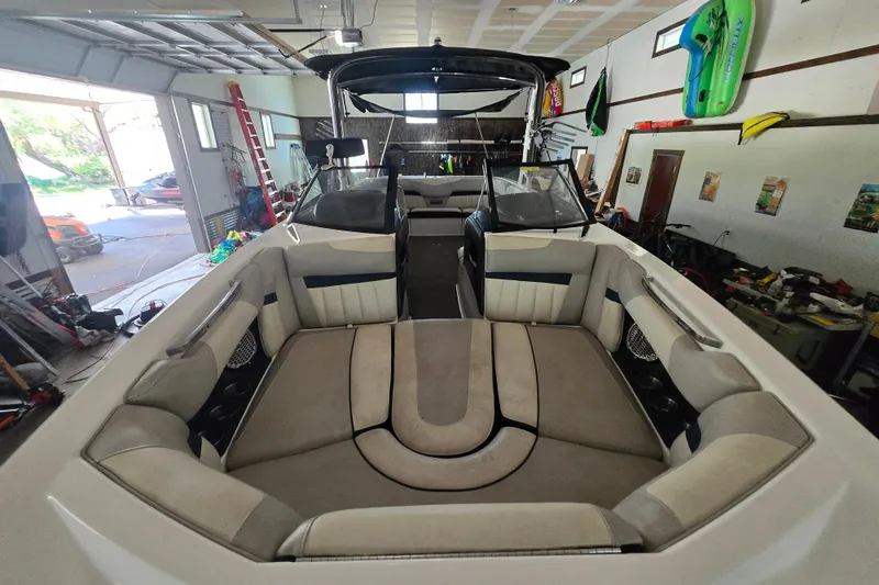 Slide: The Image of 2013 Malibu Wakesetter 24 MXZ boat interior in a garage setting. - 21