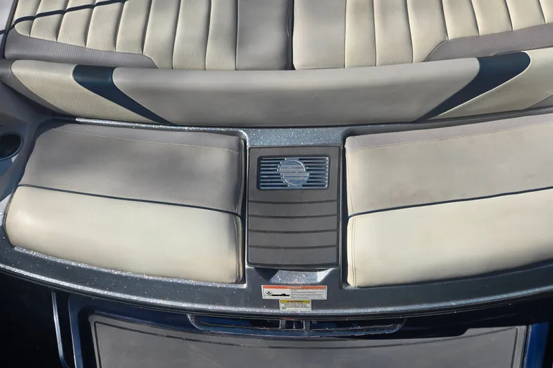 Slide: The Image of 2013 Malibu Wakesetter 24 MXZ boat interior with beige and gray seating. - 5