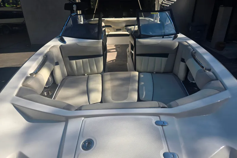 Slide: The Image of 2013 Malibu Wakesetter 24 MXZ boat interior with spacious seating and sleek design. - 3