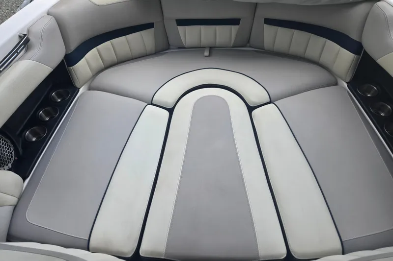 Slide: The Image of 2013 Malibu Wakesetter 24 MXZ boat interior with cushioned seating and cup holders. - 32
