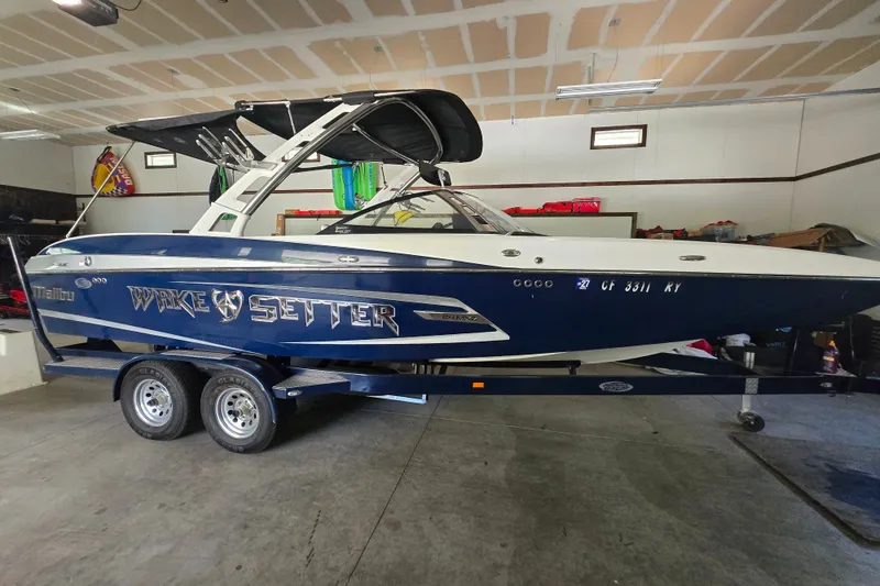 Slide: The Image of 2013 Malibu Wakesetter 24 MXZ boat in garage on trailer. - 20