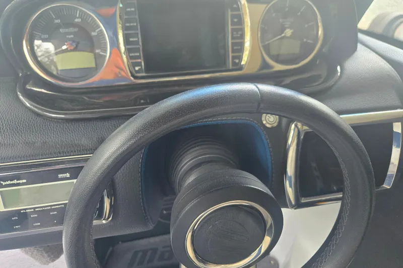 Slide: The Image of Dashboard and steering wheel of a 2013 Malibu Wakesetter 24 MXZ boat. - 34
