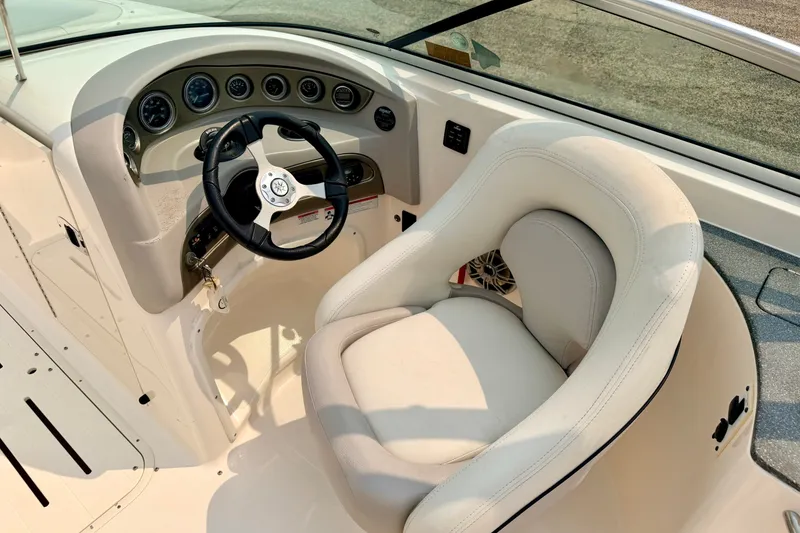 Slide: The Image of Steering console of a 2012 Bryant 268 boat with gauges and plush seating. - 51