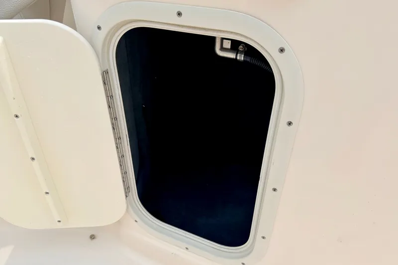 Slide: The Image of Open hatch on a 2012 Bryant 268 boat, showing interior compartment. - 48