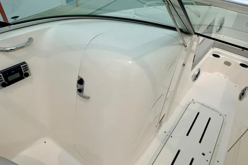 Slide: The Image of Interior of a 2012 Bryant 268 boat, featuring a sleek white design and modern controls. - 64
