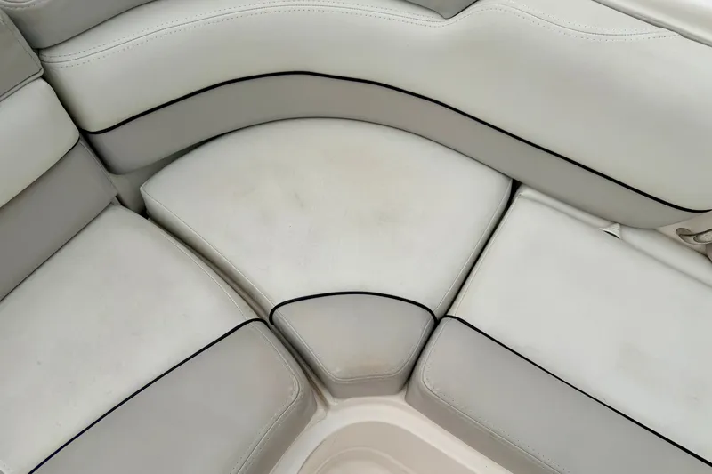 Slide: The Image of White leather seating on a 2012 Bryant 268 boat, featuring black trim accents. - 39