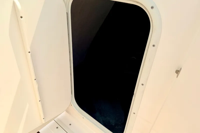 Slide: The Image of Open hatch on a 2012 Bryant 268 boat, showing interior access. - 75