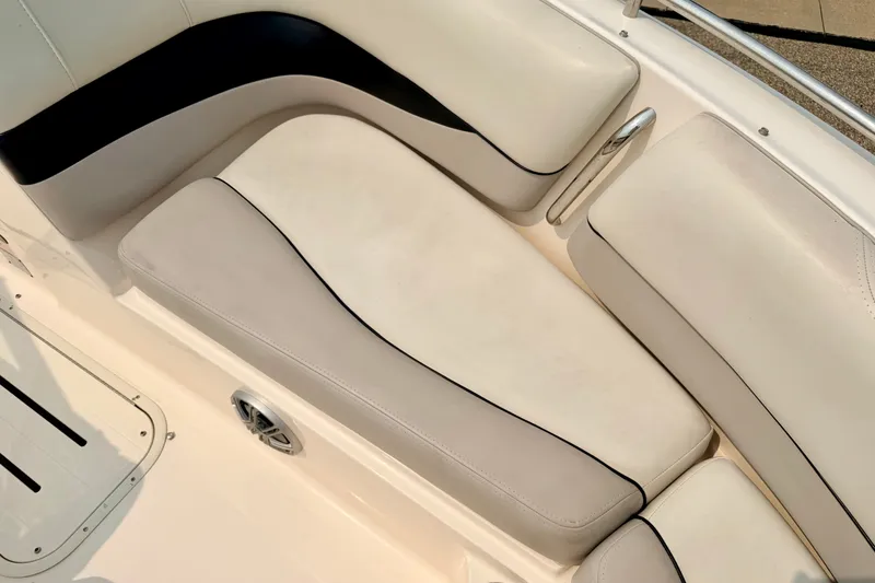 Slide: The Image of Luxurious seating on a 2012 Bryant 268 boat, featuring cream and black upholstery. - 77