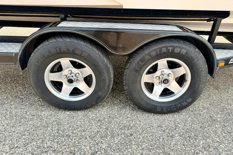 Slide: The Image of Trailer wheels with Gladiator tires on a 2012 Bryant 268 boat trailer. - 115
