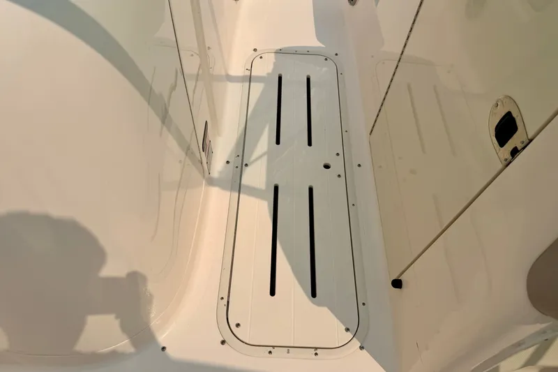 Slide: The Image of Interior view of a 2012 Bryant 268 boat, featuring a sleek, white deck design. - 70