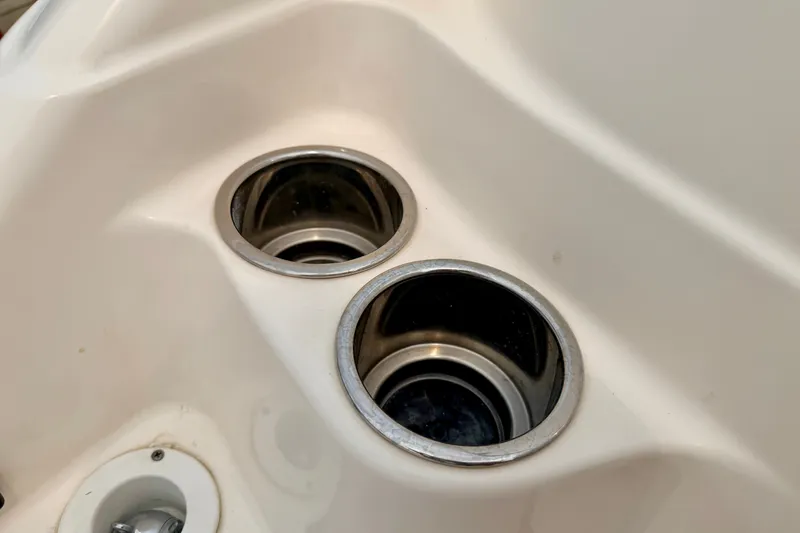 Slide: The Image of Cup holders on a 2012 Bryant 268 boat, featuring a sleek white surface. - 28