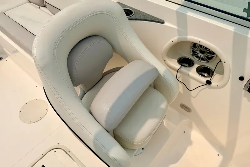 Slide: The Image of Luxurious seating on a 2012 Bryant 268 boat, featuring integrated speakers and cup holders. - 62