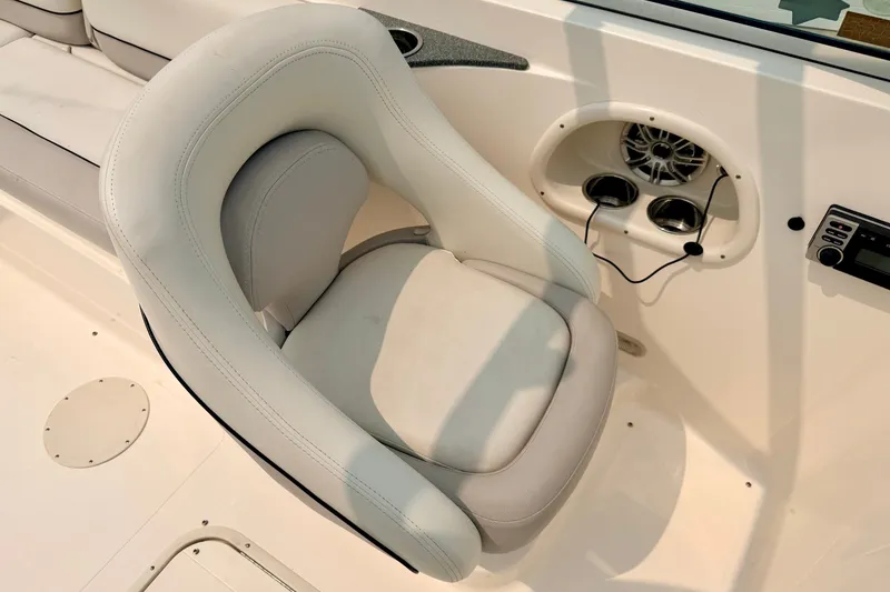 Slide: The Image of White captain's chair on a 2012 Bryant 268 boat with speaker and controls. - 61