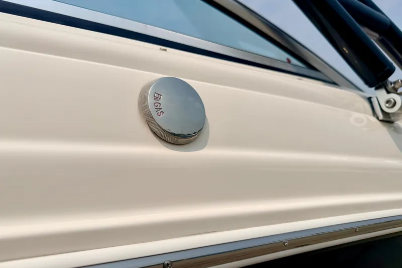Slide: The Image of Close-up of a 2012 Bryant 268 boat's gas cap on a sleek white surface. - 15