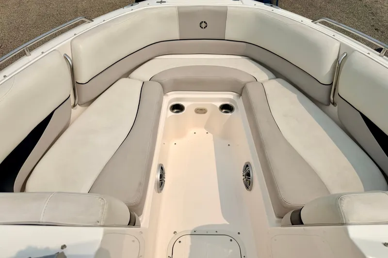 Slide: The Image of Spacious seating area on a 2012 Bryant 268 boat with beige upholstery. - 76