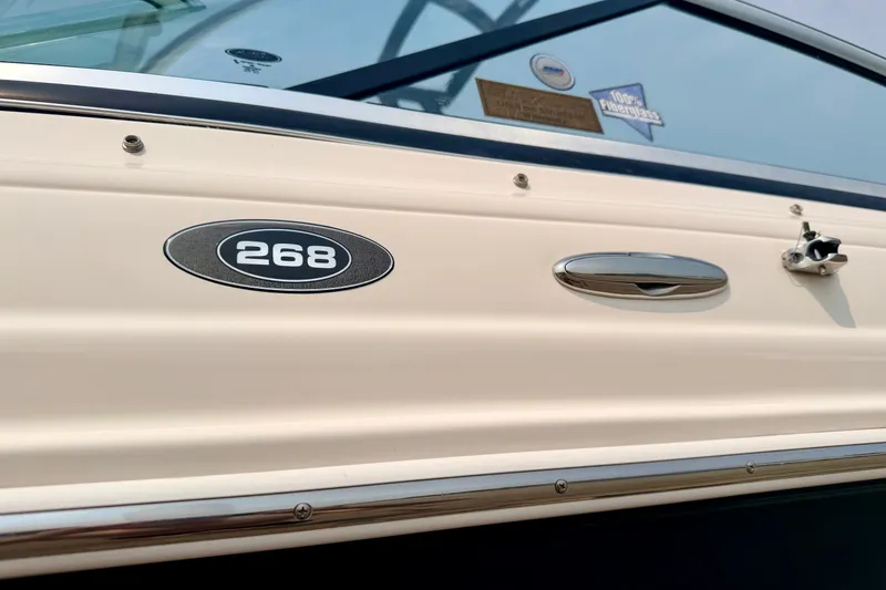 Slide: The Image of 2012 Bryant 268 boat exterior with model emblem and chrome details. - 14
