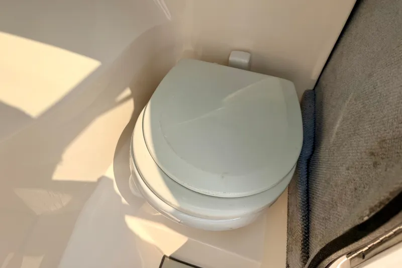 Slide: The Image of Compact toilet in a 2012 Bryant 268 boat, featuring a clean, white design. - 67