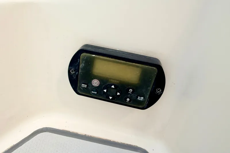 Slide: The Image of Control panel on a 2012 Bryant 268 boat dashboard, featuring buttons and display. - 27