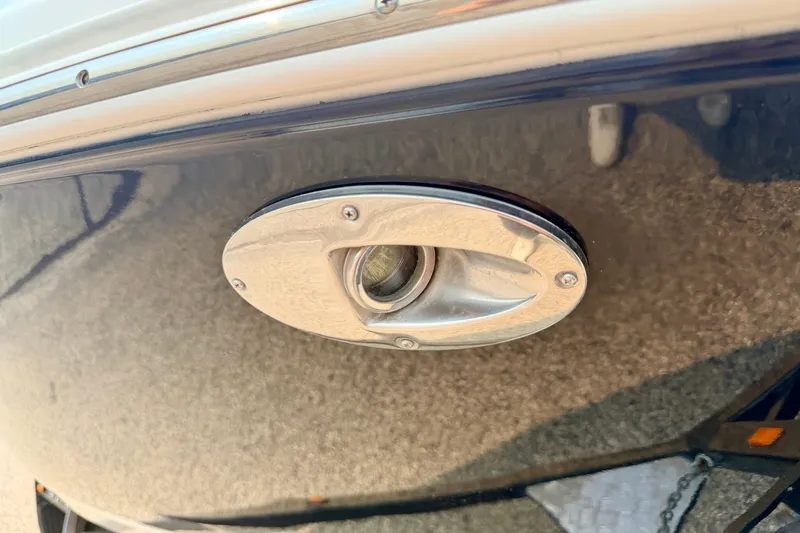 Slide: The Image of Close-up of a 2012 Bryant 268 boat's chrome light fixture on the hull. - 100