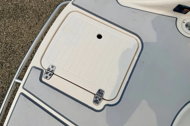 Slide: The Image of Hinged hatch on a 2012 Bryant 268 boat deck, featuring a textured surface. - 24